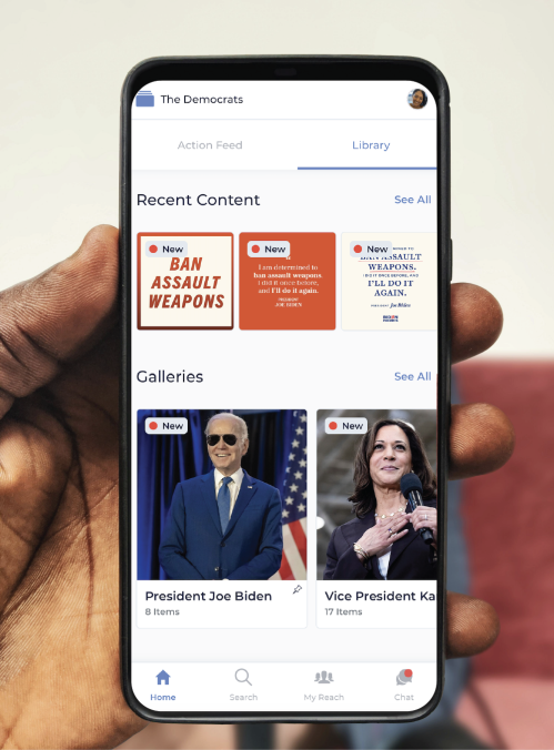 A person looking at a screenshot of the Democratic National Committee's homepage on Reach app on an iPhone